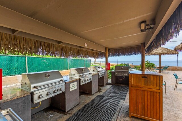 view of patio / terrace with a grill, exterior kitchen, and fence
