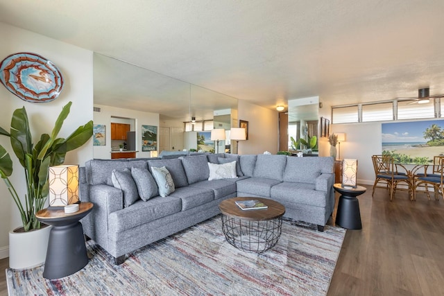 living room featuring wood finished floors and baseboards
