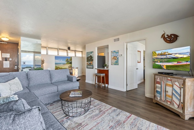 living area featuring dark wood finished floors and baseboards