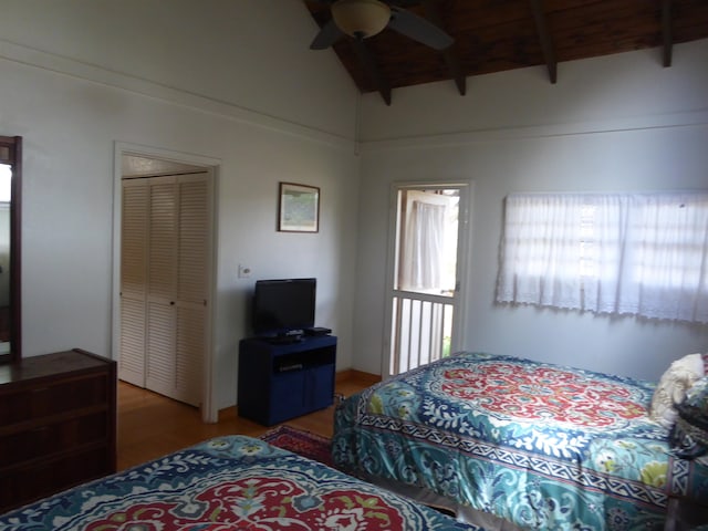 bedroom with ceiling fan, wood ceiling, a closet, dark hardwood / wood-style floors, and lofted ceiling with beams