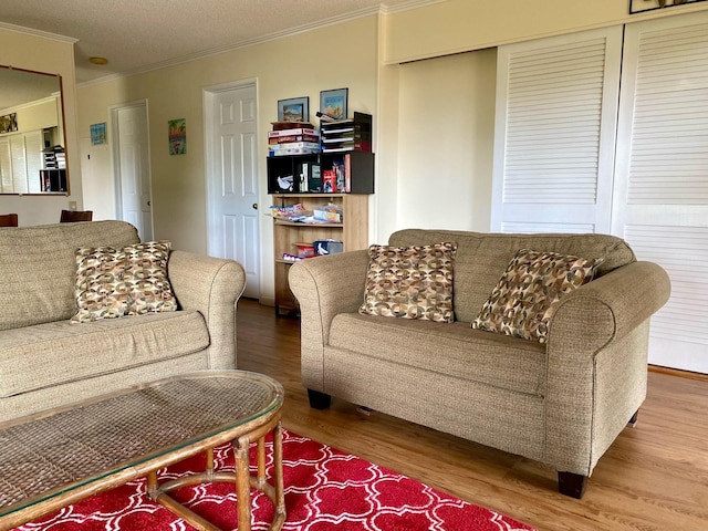 living room with ornamental molding and hardwood / wood-style floors