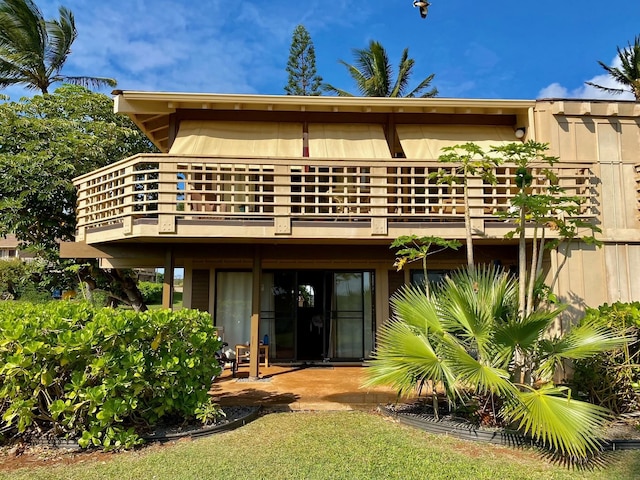 rear view of property featuring a balcony