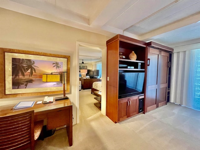 interior space featuring beamed ceiling and light carpet