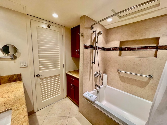 bathroom featuring tile patterned floors, tiled shower / bath, and vanity