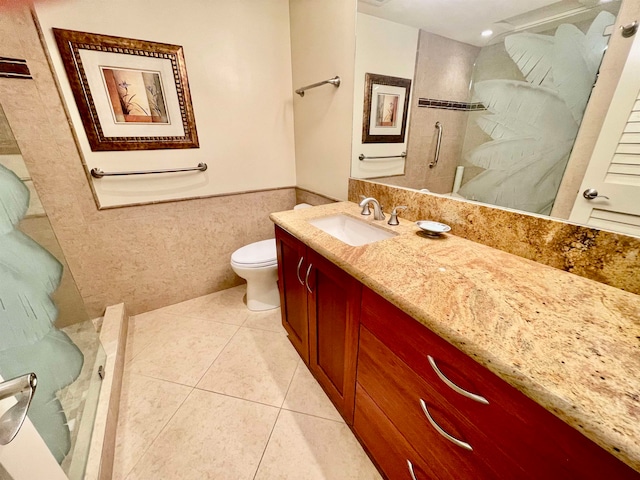 bathroom featuring tile walls, toilet, tile patterned floors, and vanity