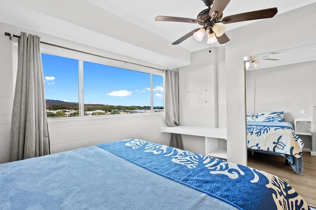 bedroom featuring hardwood / wood-style floors and ceiling fan