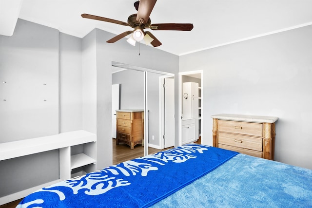 bedroom with ceiling fan, a closet, and ensuite bath