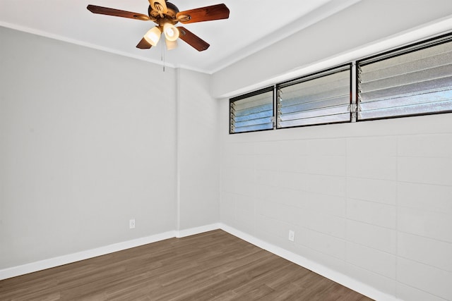 spare room featuring dark hardwood / wood-style floors and ceiling fan