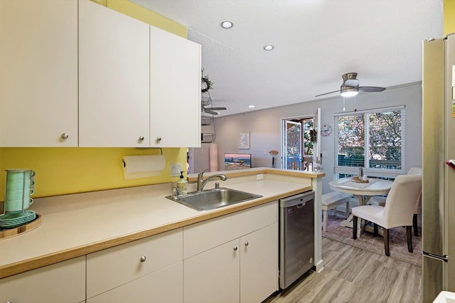 kitchen featuring white cabinetry, sink, light hardwood / wood-style floors, and appliances with stainless steel finishes