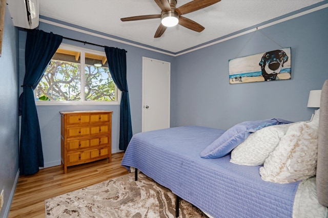 bedroom with hardwood / wood-style flooring, ornamental molding, and ceiling fan