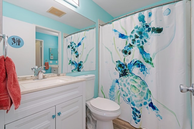 bathroom with vanity, hardwood / wood-style floors, and toilet