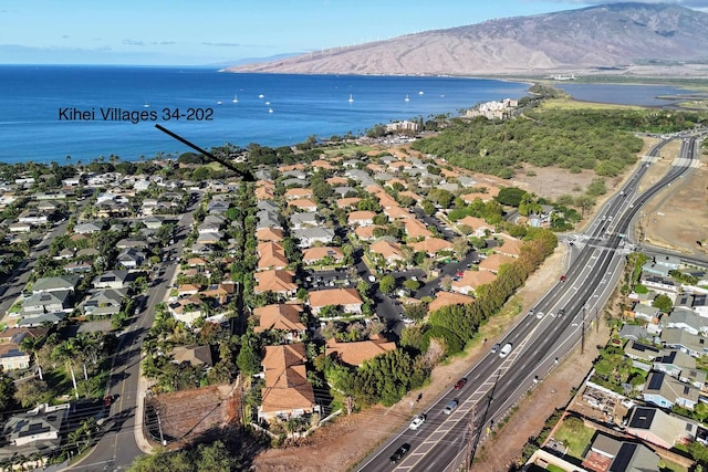 drone / aerial view featuring a water and mountain view