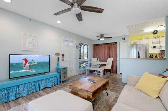 living room with hardwood / wood-style flooring and ornamental molding