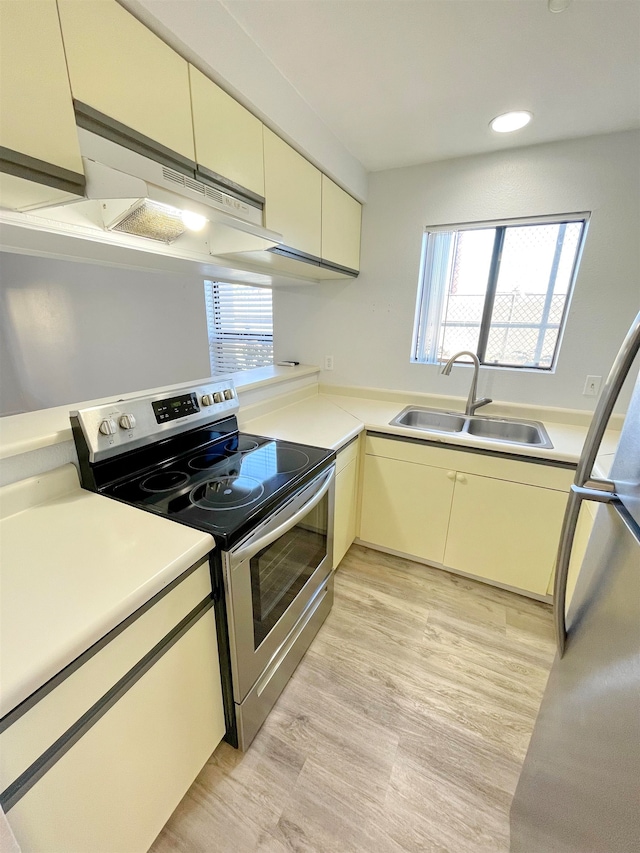 kitchen featuring light hardwood / wood-style flooring, stainless steel appliances, sink, and a wealth of natural light