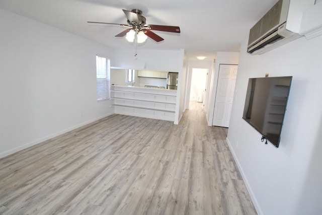 unfurnished living room with light hardwood / wood-style floors, an AC wall unit, and ceiling fan