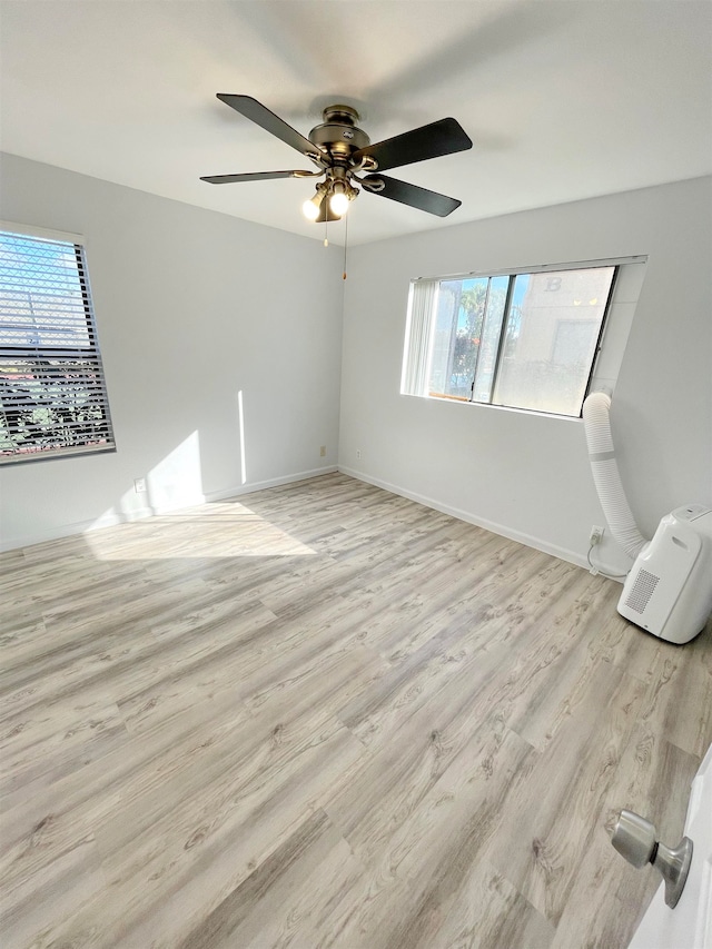 empty room featuring light hardwood / wood-style floors and ceiling fan