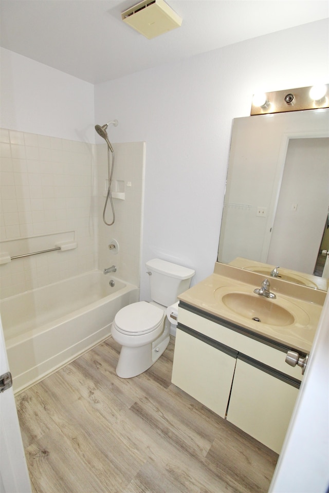 full bathroom with vanity, toilet, wood-type flooring, and shower / bathtub combination