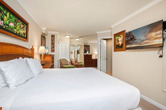 bedroom with a closet, baseboards, and crown molding