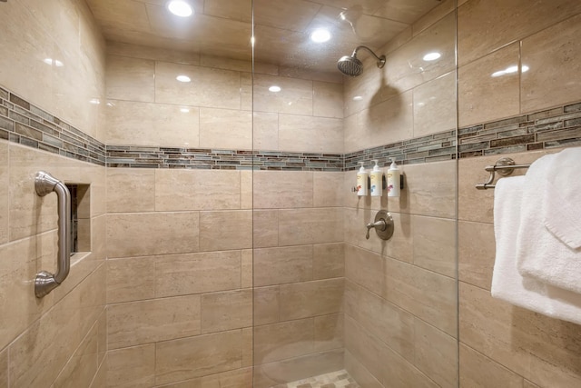 full bathroom with recessed lighting and a tile shower