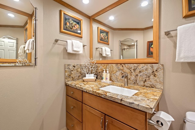 bathroom featuring crown molding, backsplash, toilet, and vanity