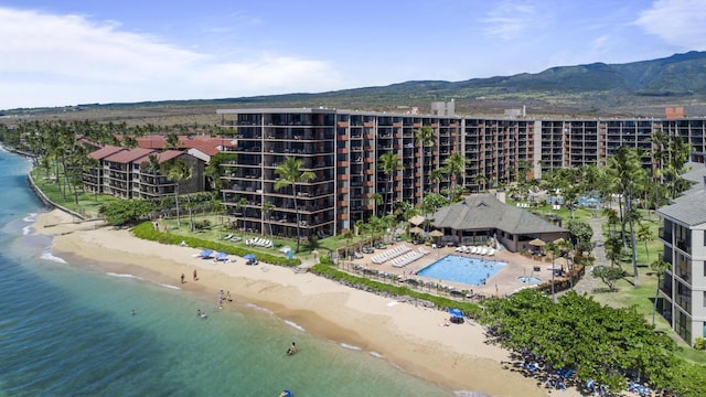 bird's eye view featuring a water view and a beach view