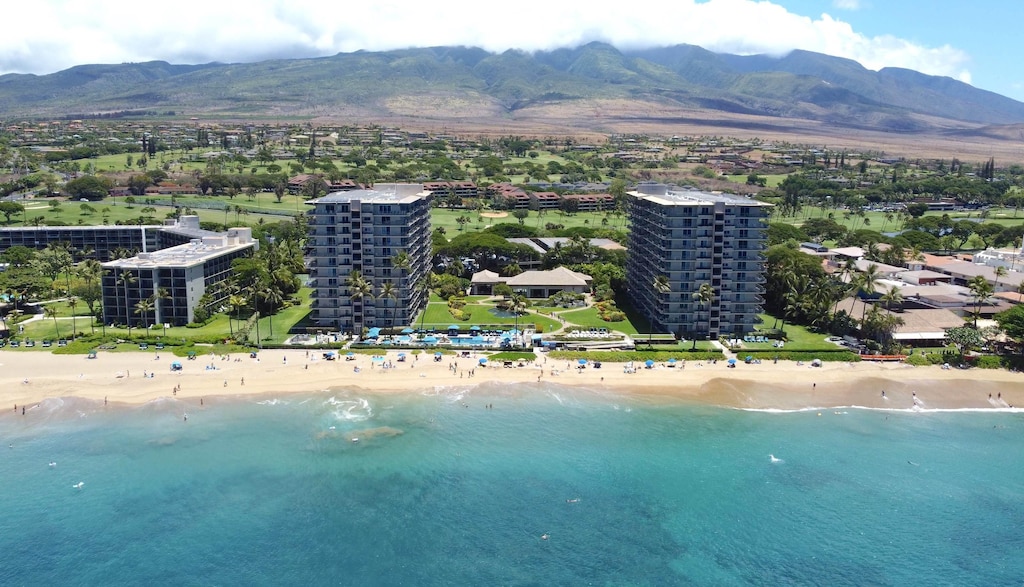 birds eye view of property with a view of city, a beach view, and a water and mountain view