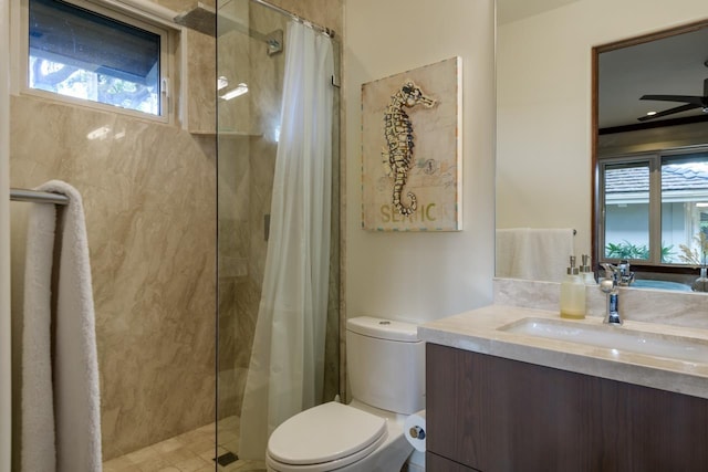 bathroom with plenty of natural light, vanity, a shower with shower curtain, and toilet