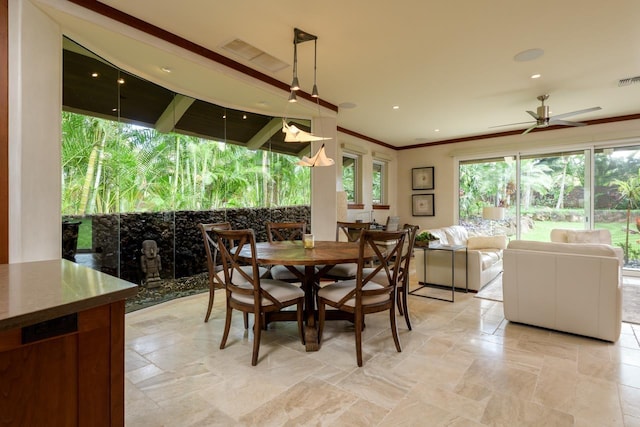 dining space featuring ceiling fan and ornamental molding