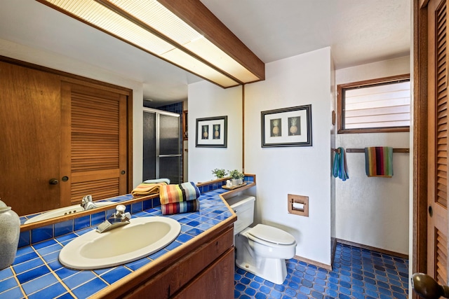 bathroom with toilet, tile floors, and vanity