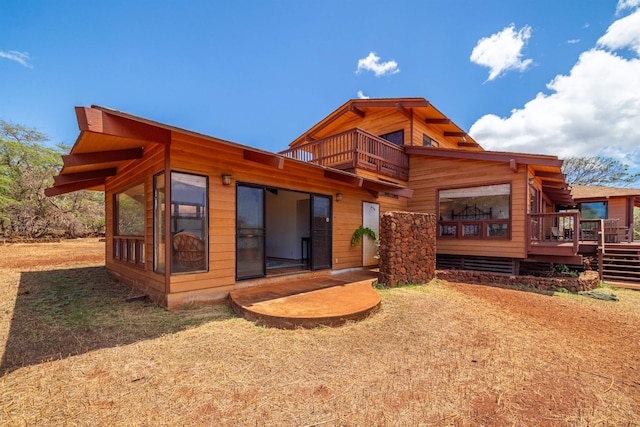 rear view of house with a wooden deck