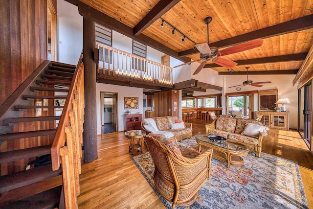 living room with wood ceiling, ceiling fan, track lighting, and light wood-type flooring