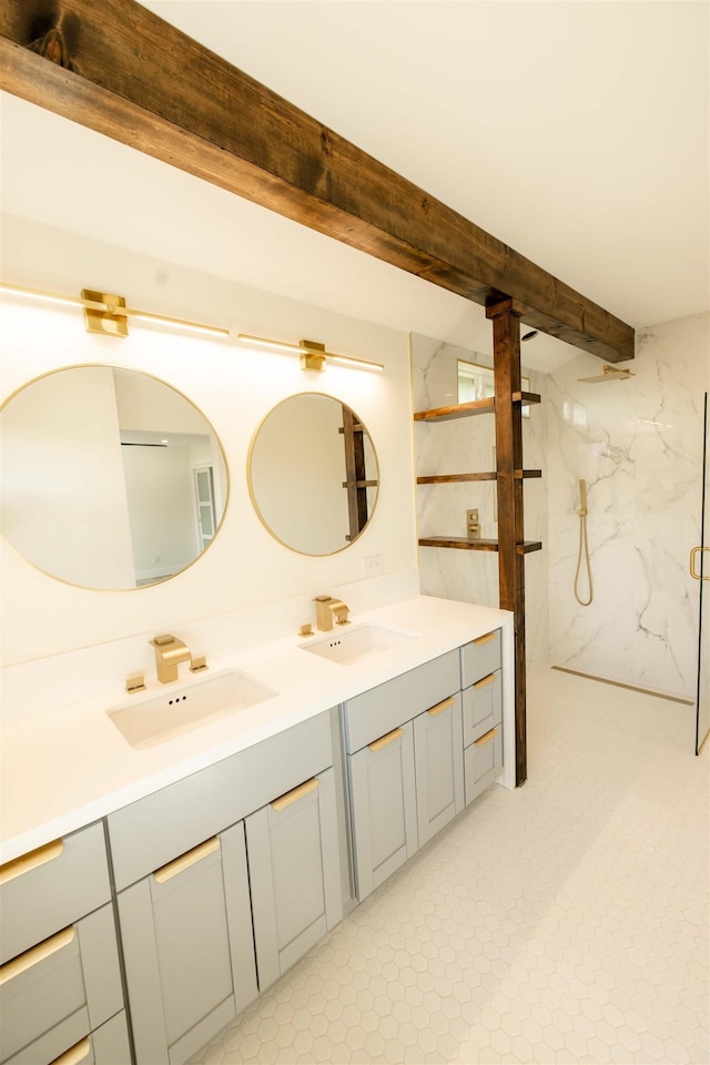 bathroom featuring beam ceiling, double vanity, a marble finish shower, and a sink