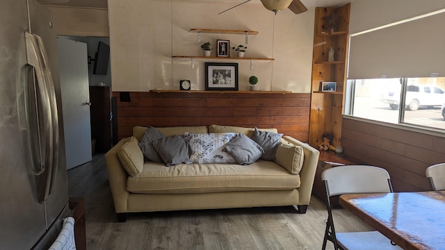 living room with ceiling fan and wood-type flooring