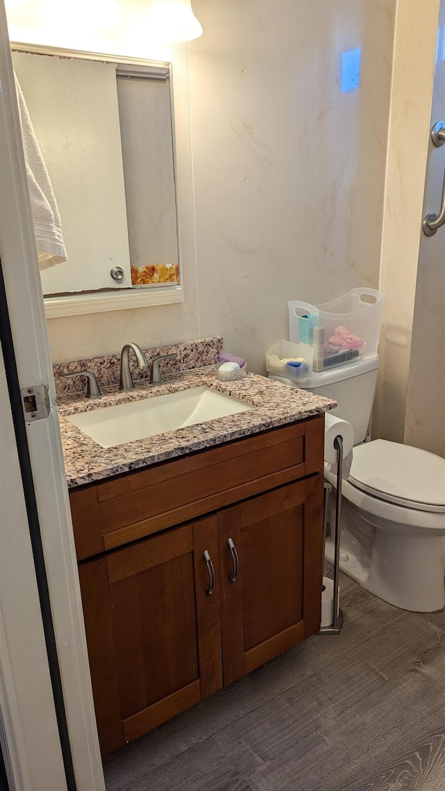 bathroom featuring hardwood / wood-style floors, vanity, and toilet