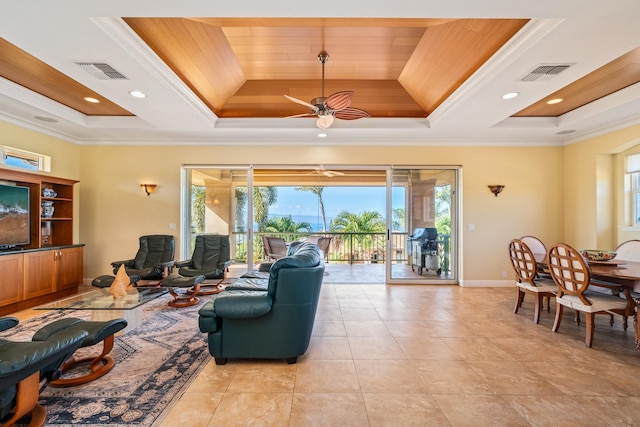 living room with a raised ceiling, ceiling fan, crown molding, and wood ceiling