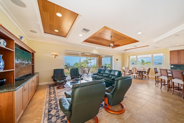 tiled living room with a raised ceiling, ceiling fan, and crown molding