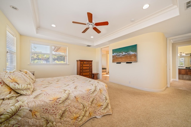 carpeted bedroom with a raised ceiling, ceiling fan, and crown molding