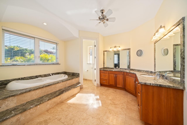 bathroom with vanity, tiled bath, and ceiling fan