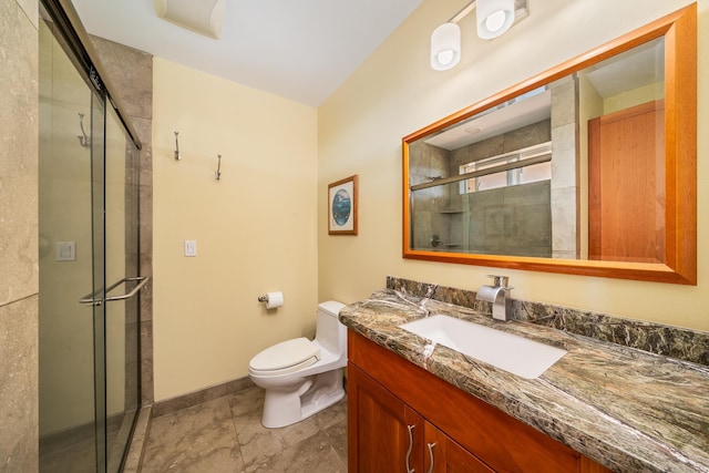 bathroom featuring vanity, toilet, and a shower with shower door