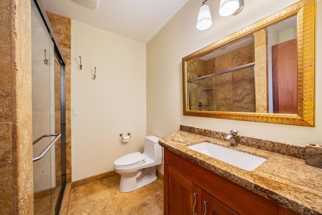 bathroom with toilet, vanity, and walk in shower