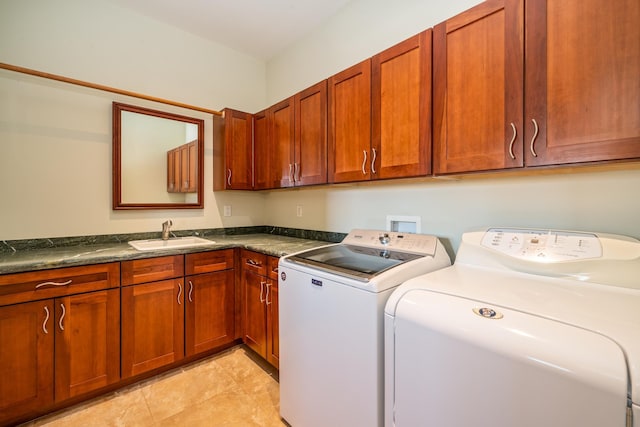 laundry room with cabinets, washer and dryer, and sink