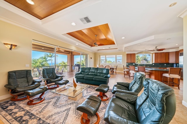 living room with wooden ceiling, crown molding, ceiling fan, light tile patterned floors, and a tray ceiling