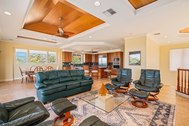 living room with a tray ceiling, wood ceiling, and ornamental molding