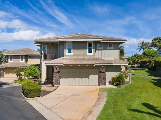 view of front of house featuring a front yard and a garage