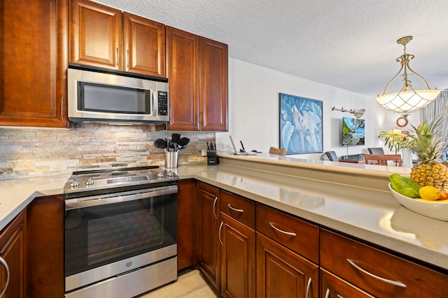 kitchen with pendant lighting, backsplash, stainless steel appliances, a textured ceiling, and kitchen peninsula