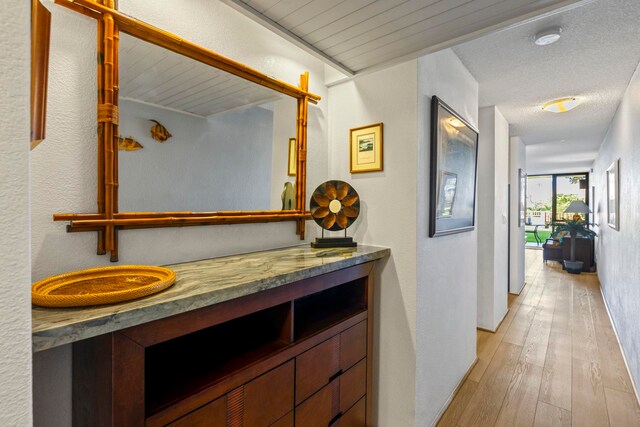 bathroom with wood-type flooring, vanity, and a textured ceiling