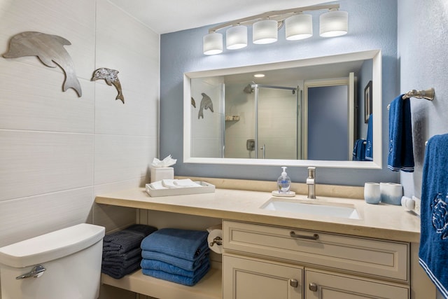 bathroom with an enclosed shower, vanity, and toilet