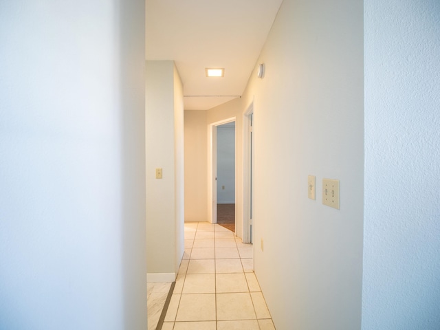 hall with light tile patterned floors