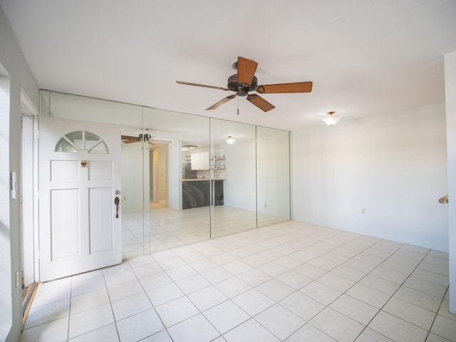 unfurnished bedroom with ceiling fan and light tile patterned floors