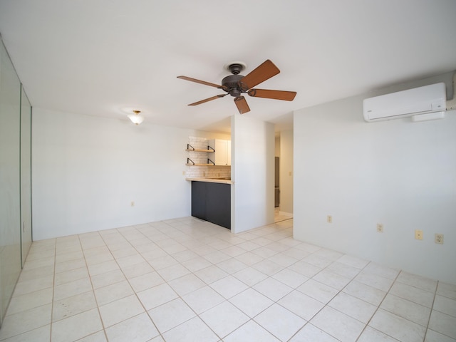 tiled spare room with ceiling fan and a wall mounted AC